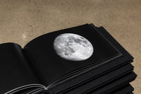 Decade, book, 2015 Each book in Decade contains images of the 28 different phases of the lunar month. Each book begins with a crescent moon that progress toward the full moon and ends with a new moon calendar.